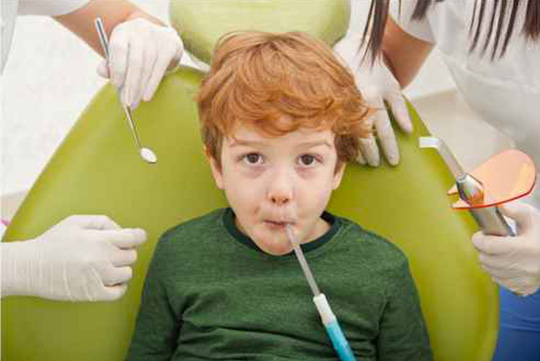 Enfant sur siège de dentiste